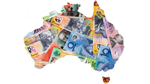 Getty Images A map of Australia covered with Australian bank notes