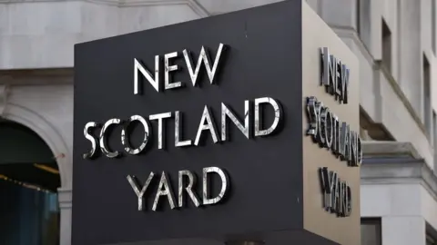 PA Media File image showing the rotating New Scotland Yard sign.