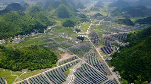 Getty Images This photo taken on June 10, 2017 shows greenhouses built with solar panels on their roofs, in Yang Fang village in Anlong, in China's southwest Guizhou province.