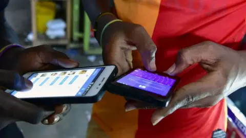 AFP People browse social media on their smartphones.