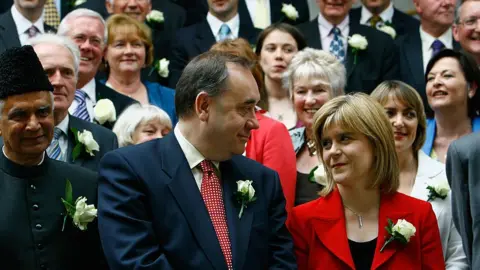 Getty Images Alex Salmond SNP leader and Nicola Sturgeon deputy leader stand with SNP's 47 newly elected MSP's after taking their oath in a swearing in ceremony at the Scottish Parliament May 9, 2007 in Edinburgh, Scotland