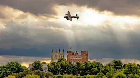 Claire Hartley Lancaster bomber flying over Tattershall Castle