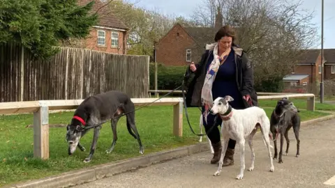 Simon Spark/BBC Kerry Elliman with some of her greyhounds