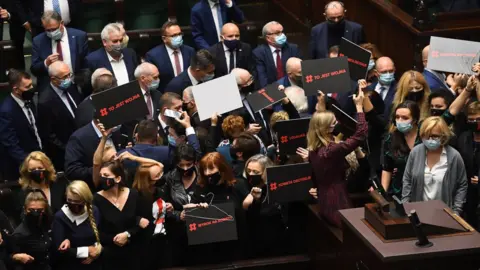 EPA Female opposition deputies block the rostrum of the Sejm as the "For Life" programs were announced in the Lower House in Warsaw