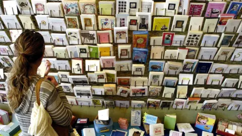 Getty Images A woman choosing a Mother's Day card