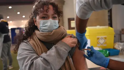 EPA Woman receives vaccine in London