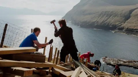 Visit Faroe Islands/Tróndur Dalsgarð Pink Group members build steps in Gjógv