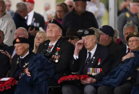 Gareth Fuller/PA Media A D-Day veteran wipes away tears