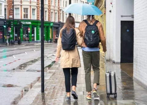 Getty Images Couple walking on a pavement in London