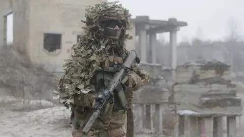 Getty Images A Ukrainian soldier wearing camouflage while taking part in drills