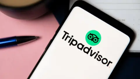 Getty Images TripAdvisor logo on phone