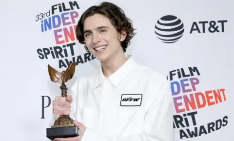 Getty Images Timothee Chalamet beams with his award