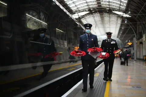 Victoria Jones / PA Wire Military personnel carry poppy wreaths at Paddington Station in London, for 'Poppies to Paddington'.