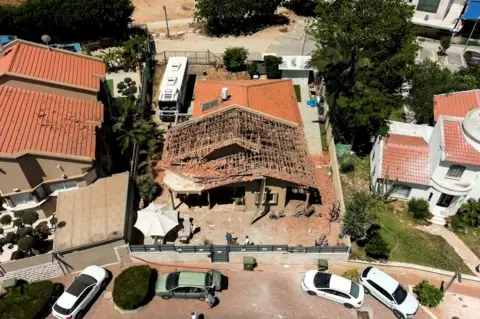 Reuters A drone picture shows the house of the El-Gazar family which was damaged after a rocket was fired from Gaza towards Israel, in Sderot, southern Israel May 15, 2021