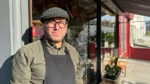 Hakan Toklu outside his shop on Surrey Street