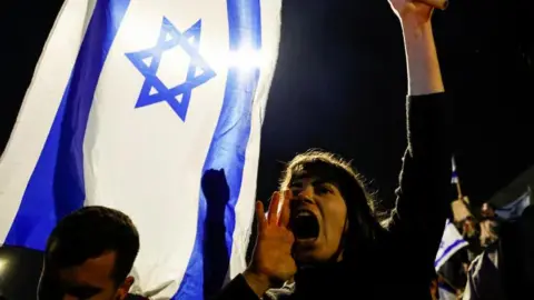 Reuters A woman yells while holding an Israeli flag