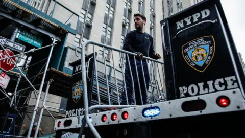 Getty Images Workers with the NYPD set up barricades outside the offices of the Manhattan District Attorney on April 1, 2023 in New York City.