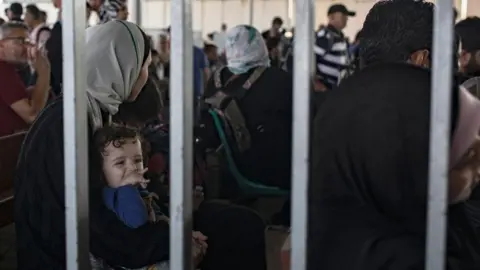 EPA-EFE/REX/Shutterstock People waiting at the Rafah crossing