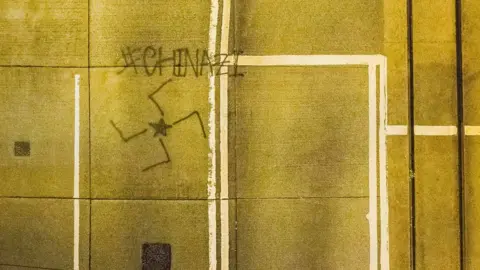 Getty Images Graffiti saying Chinazi with a swastika symbol in Hong Kong