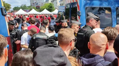 Suzanne Gower Police vans parked in a Liverpool fan zone in Paris