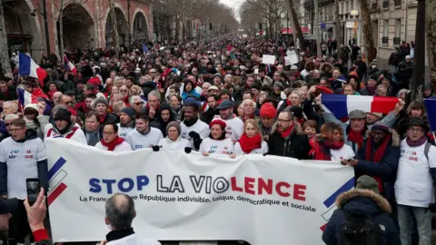 Reuters Red scarves - opponents of the yellow vests - take part in a rally in Paris, January 27, 2019