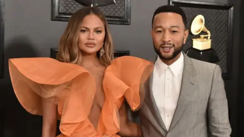 Getty Images Chrissy Teigen and John Legend at the Grammy Awards in January 2020