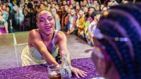 Getty Images A participant gets up close with the judges at the Fairy Tale Ball in Madrid, Spain in 2022