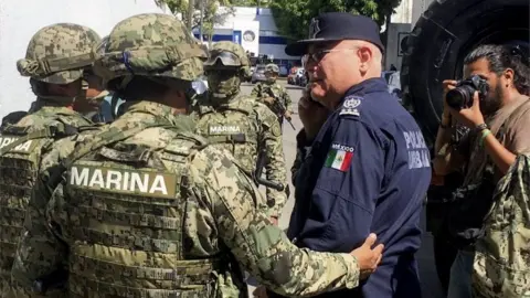 AFP Marines escort Max Lorenzo Sedano after they took control in Acapulco on September 25, 2018.