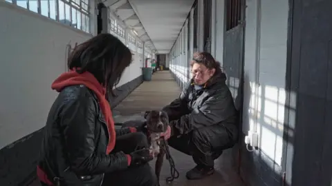 Year of the Dog Simone alongside Roxanne from DOTS with a dog at the charity's sanctuary