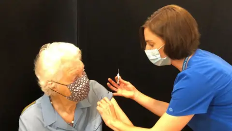 BBC/Shaun Whitmore A patient is given a flu vaccine in Aldeburgh