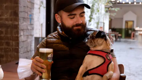 Pacemaker Thomas McAuley and dog Jo in White’s Tavern