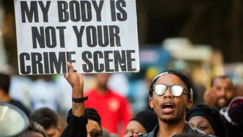 Getty Images Protesters at an anti-gender violence rally