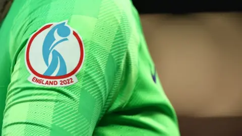 Getty Images A detail view of the England 2022 logo on the shirt of Mary Earps of England