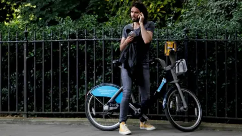 Getty Images Russell Brand on bike after joining anti austerity protests on 21 June 2014