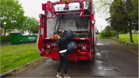 woman dealing with her own rubbish