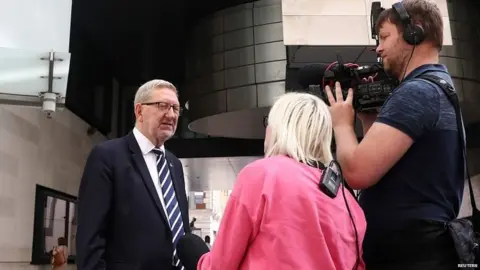 Reuters Unite general secretary Len McCkuskey talking to the media