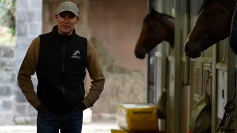 Jamie Niblock/BBC George Scott in the stables