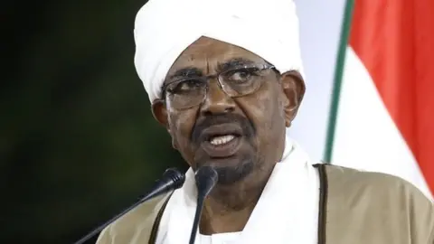 Getty Images Sudan's President Omar al-Bashir delivers a speech to the nation at the presidential palace in the capital Khartoum, 22 February 2019