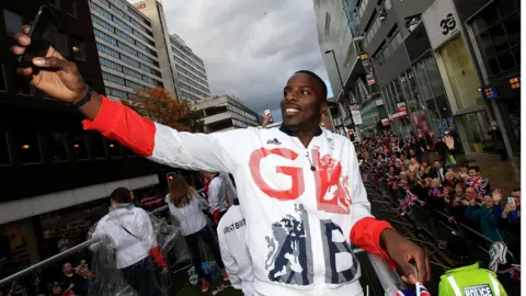 Getty Images Lawrence Okolie taking a selfie at the Team GB victory parade