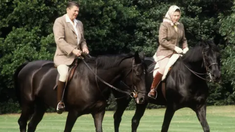 Getty Images US President Ronald Reagan horse riding with the Queen at Windsor in June 1982