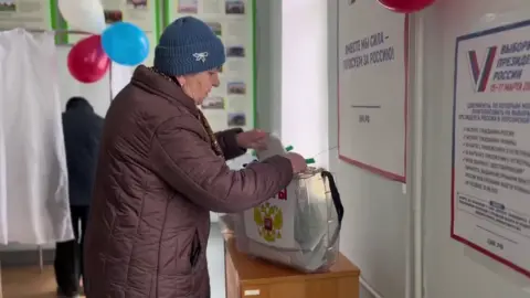 Russian-controlled Kherson election commission A woman votes in occupied Kherson