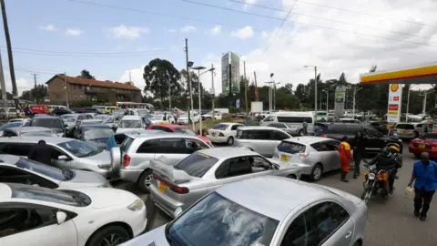 AFP Motorists queue to fuel at a Shell petrol station on September 6, 2018, in Nairobi as a strike called by petroleum transporters protesting against new government tax enters its fourth day. (Photo by SIMON MAINA / AFP)