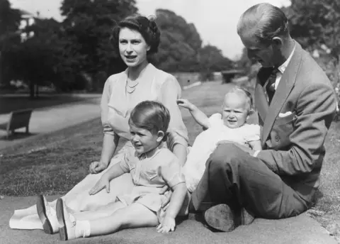 Getty Images 9th August 1951: Princess Elizabeth and Prince Philip, Duke of Edinburgh with their two children, Prince Charles and Princess Anne in the grounds of Clarence House, London