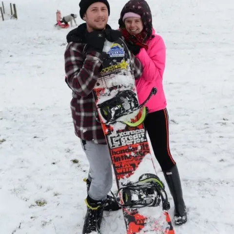 Wales News Service Dean Wager and Krysti Henderson with their snowboard