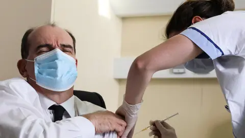 Getty Images Prime Minister Jean Castex is vaccinated with the AstraZeneca Covid-19 vaccine on March 19, 2021