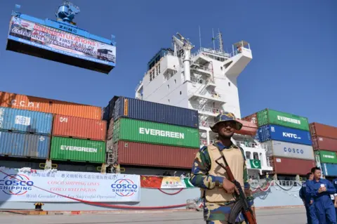 AAMIR QURESHI/AFP/Getty Images Pakistani Naval personnel stand guard near a ship carrying containers at the Gwadar Port