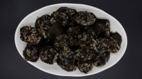 Reuters A photo illustration shows North Korean sausage "sundae" cooked by North Korean defector Hong Eun-hye at her North Korean food store in Seoul, South Korea, 28 September 2017.