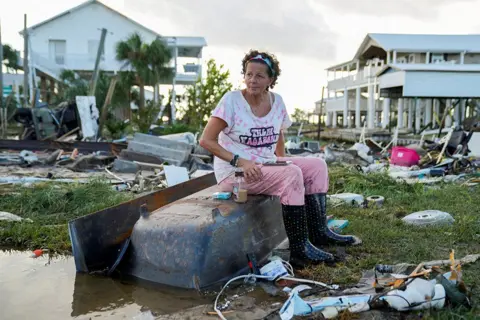 Cheney Orr / Reuters Jewell Baggett, 51, sits on a bathtub amid the wreckage of her home