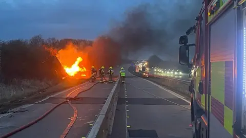 Nottinghamshire Fire and Rescue Service Fire crews fight a burning lorry