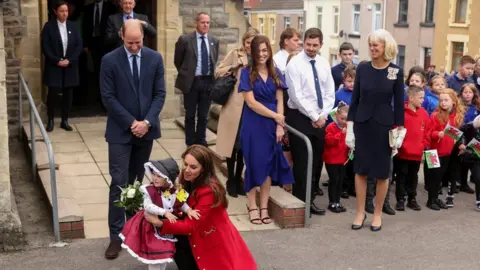 Reuters Catherine, Princess of Wales, embraces Charlotte, two, during a visit to St Thomas Church in Swansea